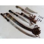 Two early 20th century North African daggers with straw-work inlaid leather handles and sheaths,