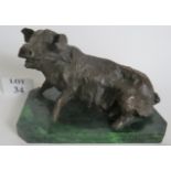 A bronze sculpture of a pig on a green marble plinth,