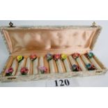 A set of twelve vintage ceramic knife rests decorated with hand made foliate appliques,