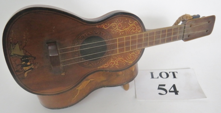 A Spanish guitar with inlaid decoration, early 20th century, fitted with a musical box, hinged lid,