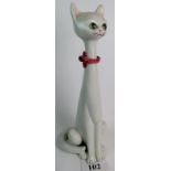 A large c1960's Italian ceramic model of a seated cat with pink bow round it's neck,