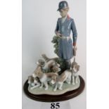 A Lladro group depicting a Huntsman & Hounds on naturalistic base, modelled by Valala,