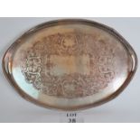 A large silver plated serving tray with engraved decoration and four bun feet,