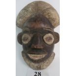 An African Tribal carved wooden mask, most likely Punu, South Gabon, some painted decoration.