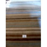 A contemporary wool rug with cream, blue and brown stripes, originals from John Lewis,