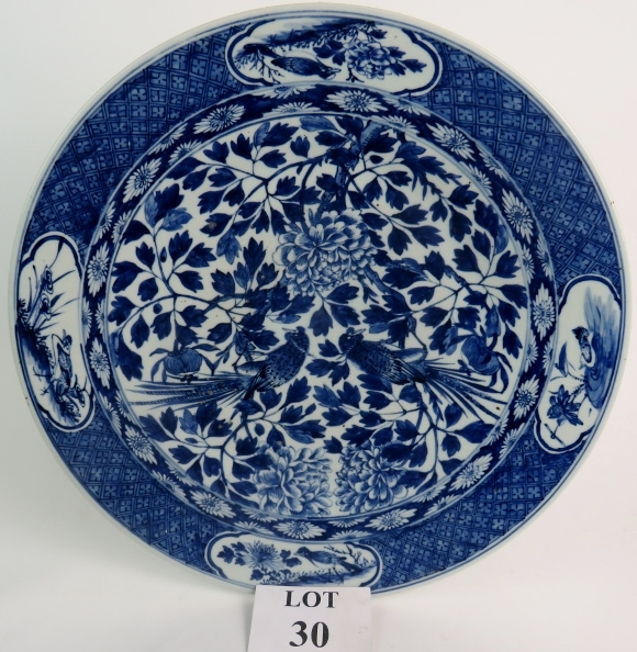 An antique Chinese blue and white porcelain charger of impressive size,