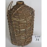 A vintage gallon of dark Navy rum in a stoneware jar, with wicker cover,