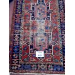 An early 20th century Persian rug with central design, some wear,