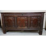 A 17th century oak coffer with carved panels to front and iron lock plate, H28" x W52" x D22",