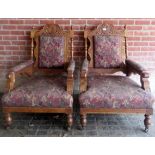 A pair of Victorian carved oak framed armchairs upholstered in a tapestry style material and with