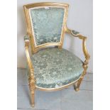 A French gilt framed armchair upholstered in a floral teal fabric,