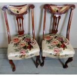 A pair of 19th century mahogany framed occasional chairs upholstered in a pale floral material,