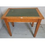 A 19th century oak writing table with a green leather top,