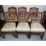 A set of 6 Edwardian oak dining chairs upholstered in a duck egg blue and gold part silk upholstery,