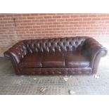 A 20th Century three seater brown leather Chesterfield sofa,