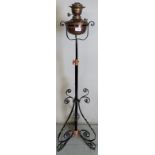 An Edwardian pedestal oil lamp with an adjustable column,