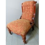 A late Victorian mahogany framed nursing chair upholstered in a tapestry style material,