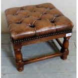 A small oak framed and leather topped footstool,