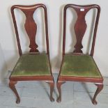 A pair of Victorian mahogany high back dining/hall chairs with green upholstered pad seats,
