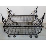 An ornate 20th century black metal fire basket,