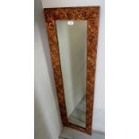 A decorative foliage moulded gilt wall mirror,