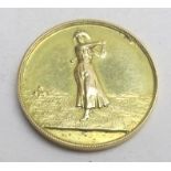 A 9ct gold golfing medallion, approx 8.7