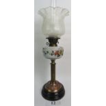 A Victorian oil lamp with enamel painted opaque glass reservoir, fluted brass column,