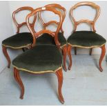 A set of four Victorian walnut framed dining chairs upholstered in a deep green velvet material,