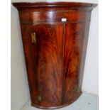 A Georgian frame mahogany bow fronted corner cupboard of good rich colour and patina,