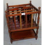 An Edwardian mahogany Canterbury with handle top over 4 compartments and shelf beneath,