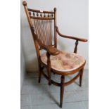 A c1900 oak country elbow chair with turned spindles to the back over a pad seat, slightly A/F,