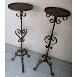 A pair of 20th century wrought iron plant stands with ornate design to a central twist column and