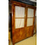 A fine 19th century walnut double cabinet with glazed doors opening to reveal internal shelves of