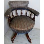A c1900 Captain's swivel desk chair with mahogany showwood in need of some attention,
