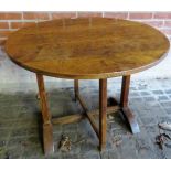 A 19th century country oak tilt top tavern table,