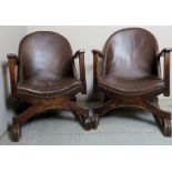 A pair of Art Deco period low armchairs upholstered in studded brown leather and terminating on