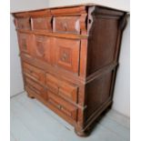 A late 17th/18th century oak split chest of 2 deep drawers over 2 drawers with geometric panels,