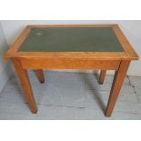 A 19th century oak writing table with a green leather top,