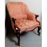 A Victorian mahogany framed armchair upholstered in a pink floral material slightly A/F,