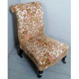 A Victorian low nursing/prayer chair upholstered in a floral material,