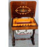 A Victorian rosewood and walnut sewing table with a fitted interior and decorative inlaid lid,