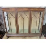 A 1920/30 mahogany glass display cabinet with 3 doors over ball and claw feet, slightly a/f,