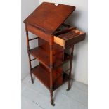 A Georgian mahogany freestanding whatnot/book stand with ring turned supports,