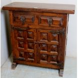 A 20th century panelled hardwood cabinet with 2 small drawers to top over double cupboard doors,