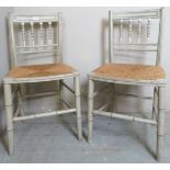 A pair of Regency painted occasional chairs with later rush seats,