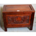 A small 20th century carved mahogany box with a lift up lid,