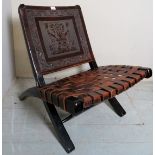 A Peruvian folding chair with embossed design to back and a latice work leather seat (very good