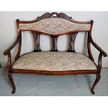 An Edwardian two seater parlour sofa in a floral material,