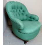 A Victorian armchair upholstered in a green deep buttoned material,