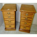 A pair of Victorian oak bedside cabinets with mahogany inlay to drawers,